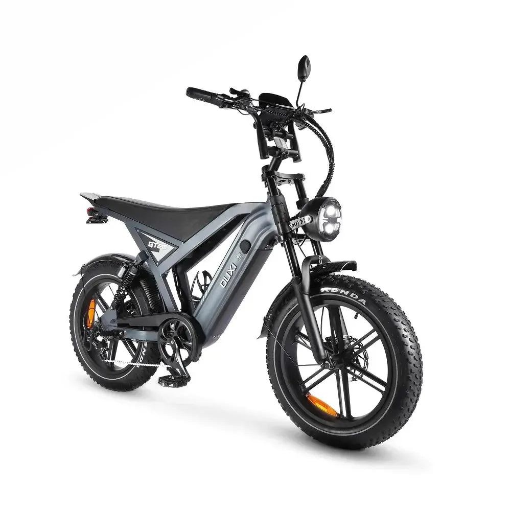 Een moderne OUXI FATBIKE GT20 – model 2026, voorzien van hydraulische remmen, een ingebouwd alarmsysteem, dikke banden, een koplamp in het midden en een matgrijs frame. Deze fatbike is uitgerust met voorvering, een bagagedrager achter, schijfremmen voor extra veiligheid en een zwart stuur.