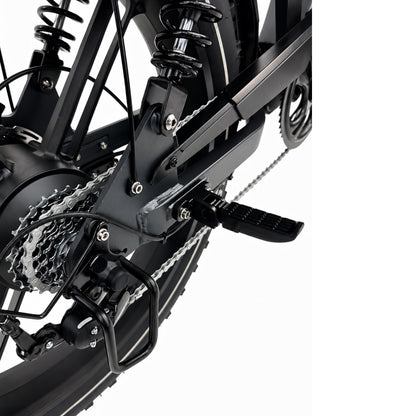 Een close-up van het achterwiel van de FATBIKE OUXI GT24 – MODEL 2026 van OUXI, waarbij de versnellingen, de derailleur, de veringveren, het pedaal en de ketting tegen een witte achtergrond goed te zien zijn.