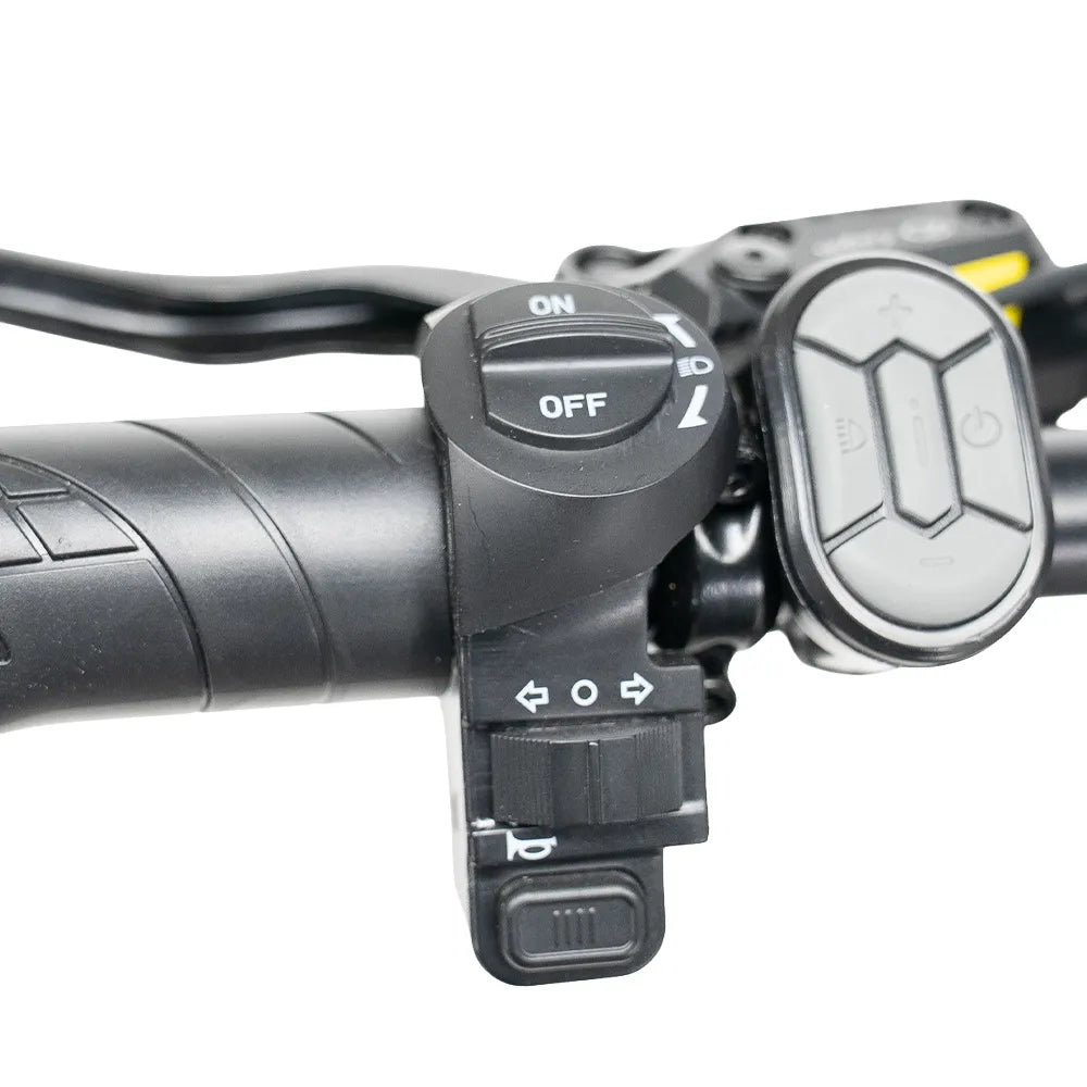 Close-up van het stuur van de FATBIKE OUXI V8 (C80) MAX - DUBBELE ACCU – MODEL 2026 van OUXI, voorzien van bedieningsknoppen zoals een AAN/UIT-draaiknop, pijlknoppen en een reeks multifunctionele bedieningselementen. Het ergonomische ontwerp zorgt ervoor dat je gemakkelijk toegang hebt tot essentiële functies voor het bedienen van de krachtige 250W-motor, het innovatieve dubbele accusysteem en de hydraulische remmen.